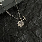 Balenciaga charm necklace with round logo pendant and hook charm on chain