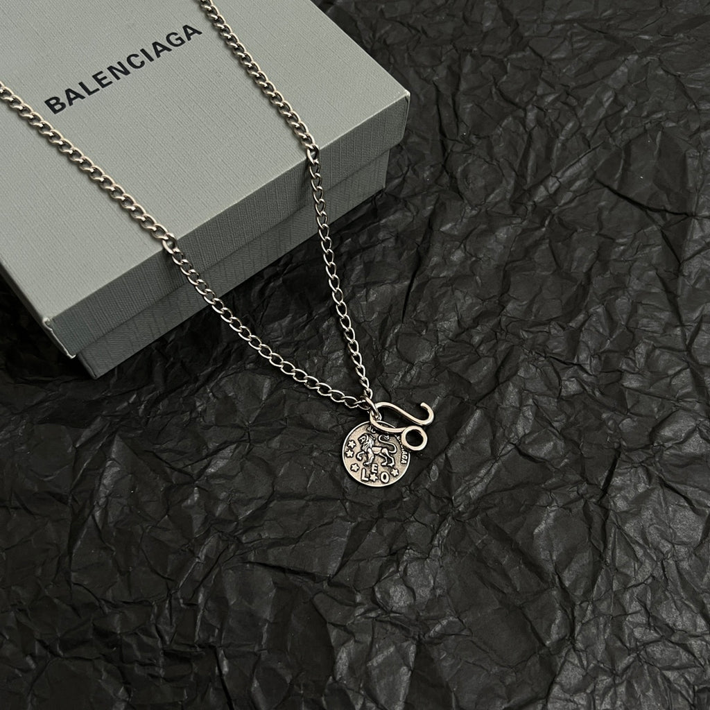 Balenciaga charm necklace with round logo pendant and hook charm on chain