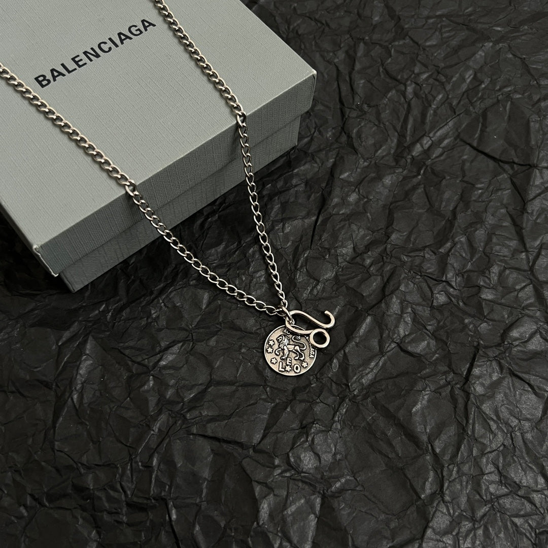 Balenciaga charm necklace with round logo pendant and hook charm on chain