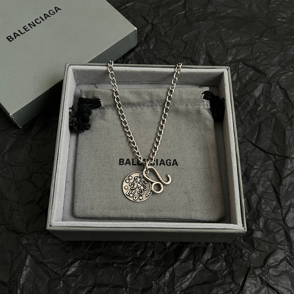 Balenciaga charm necklace with round logo pendant and hook charm on chain