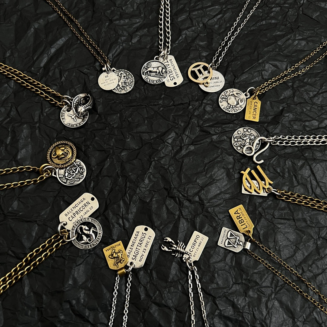 Balenciaga charm necklace assortment with mixed metal pendants and logo tags