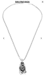 Silver chain necklace with animal claw charm pendant and rectangular engraved tag