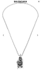 Silver chain necklace with small engraved tag and animal claw charm pendant