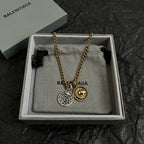 Balenciaga charm necklace with gold chain and two circular pendants in gift box