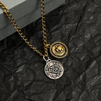 Gold-tone necklace detail with gold and silver circular pendants and engraved design