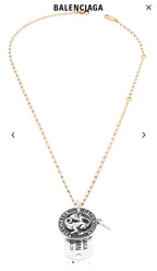 Gold charm necklace with circular zodiac coin pendant and engraved name tag