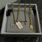 Gold charm necklace with zodiac coin, Capricorn tag, and small drop charm