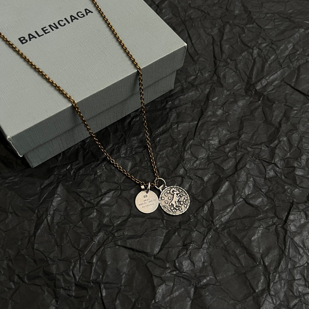 Balenciaga gold-tone charm necklace with circular pendant and round ID medallion