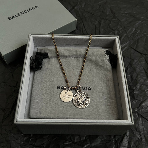 Balenciaga gold-tone charm necklace with circular pendant and round ID tags