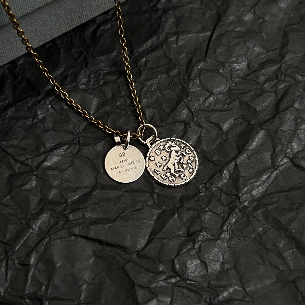 Balenciaga gold-tone charm necklace with circular pendant and round ID charm