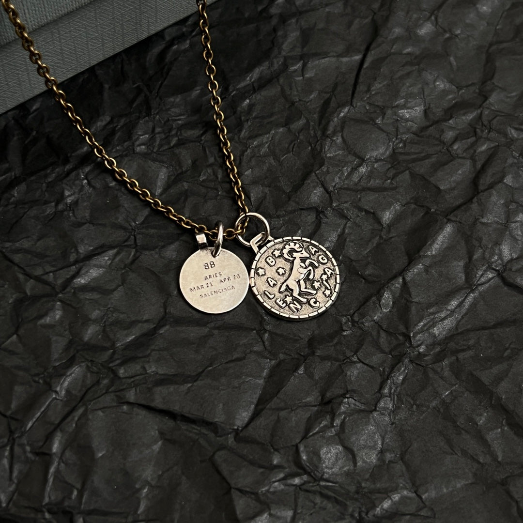 Balenciaga gold-tone charm necklace with circular pendant and round ID charm