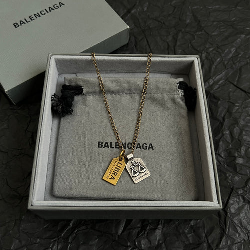 Gold-tone charm necklace with Balenciaga logo pendants in a gift box