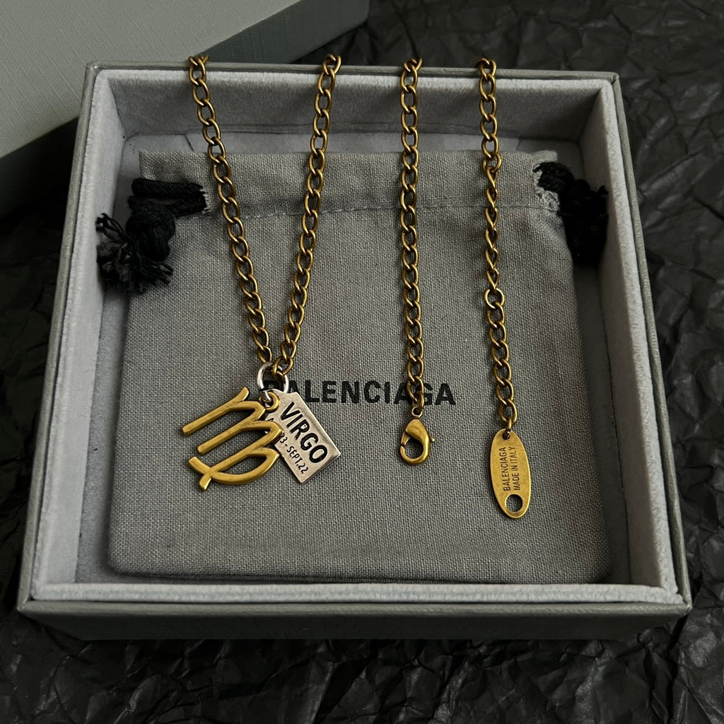 Gold-tone Virgo charm necklace set in gray gift box, multiple chains with date tags