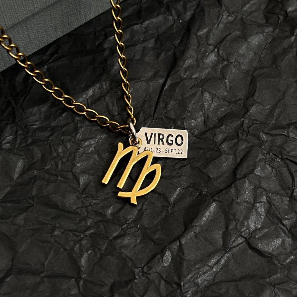 Gold-tone Virgo charm necklace close-up, pendant with VIRGO date rectangular tag