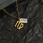 Gold-tone Virgo charm necklace close-up, pendant with VIRGO date rectangular tag