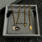 Balenciaga jewelry set in gift box: gold chain with fish medallion and tag pendant