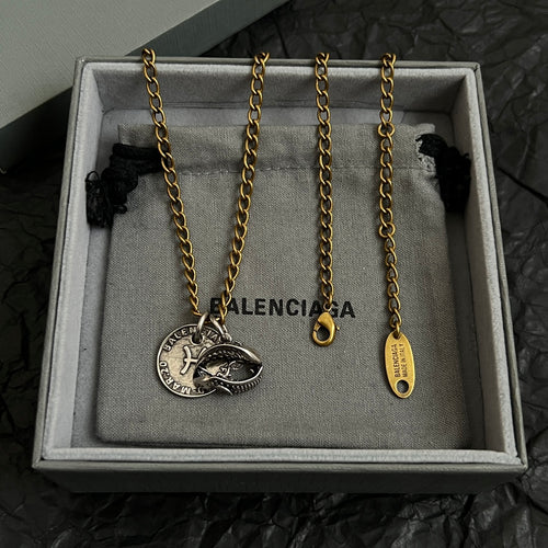 Balenciaga jewelry set in gift box: gold chain with fish medallion and tag pendant