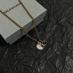 Balenciaga pendant necklace with gold chain and two circular charms