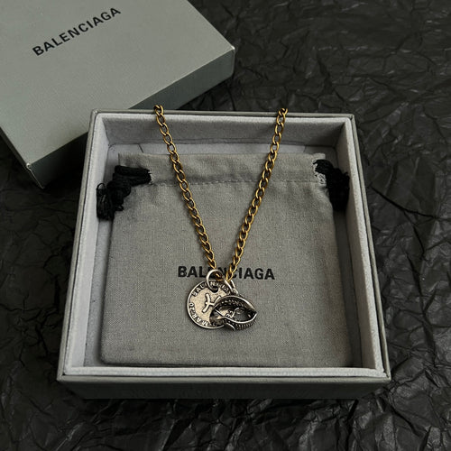 Balenciaga pendant necklace in gift box with circular fish medallion on gold chain
