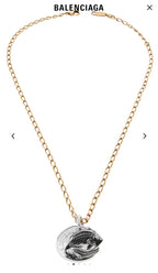 Balenciaga pendant necklace with gold chain and silver-toned fish medallion
