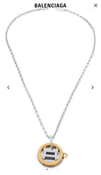 Silver chain necklace with round gold pendant and attached circular charm