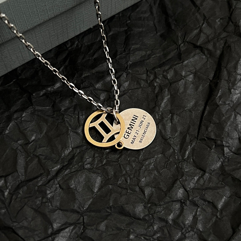 Silver chain necklace with gold Balenciaga emblem pendant and round engraved tag