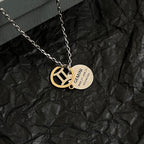 Silver chain necklace with gold Balenciaga emblem pendant and round engraved tag