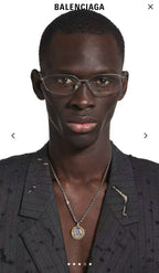 Silver chain necklace with round gold and silver Balenciaga pendant on model