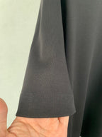 Fendi T-shirt side hem and curved stitching detail, dark gray fabric.