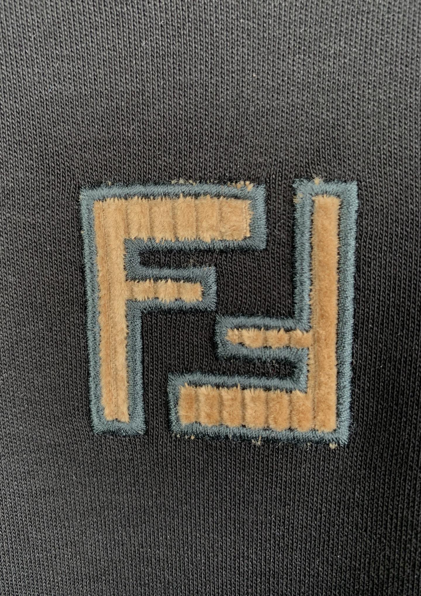 Fendi logo patch embroidery on dark gray knit T-shirt fabric.
