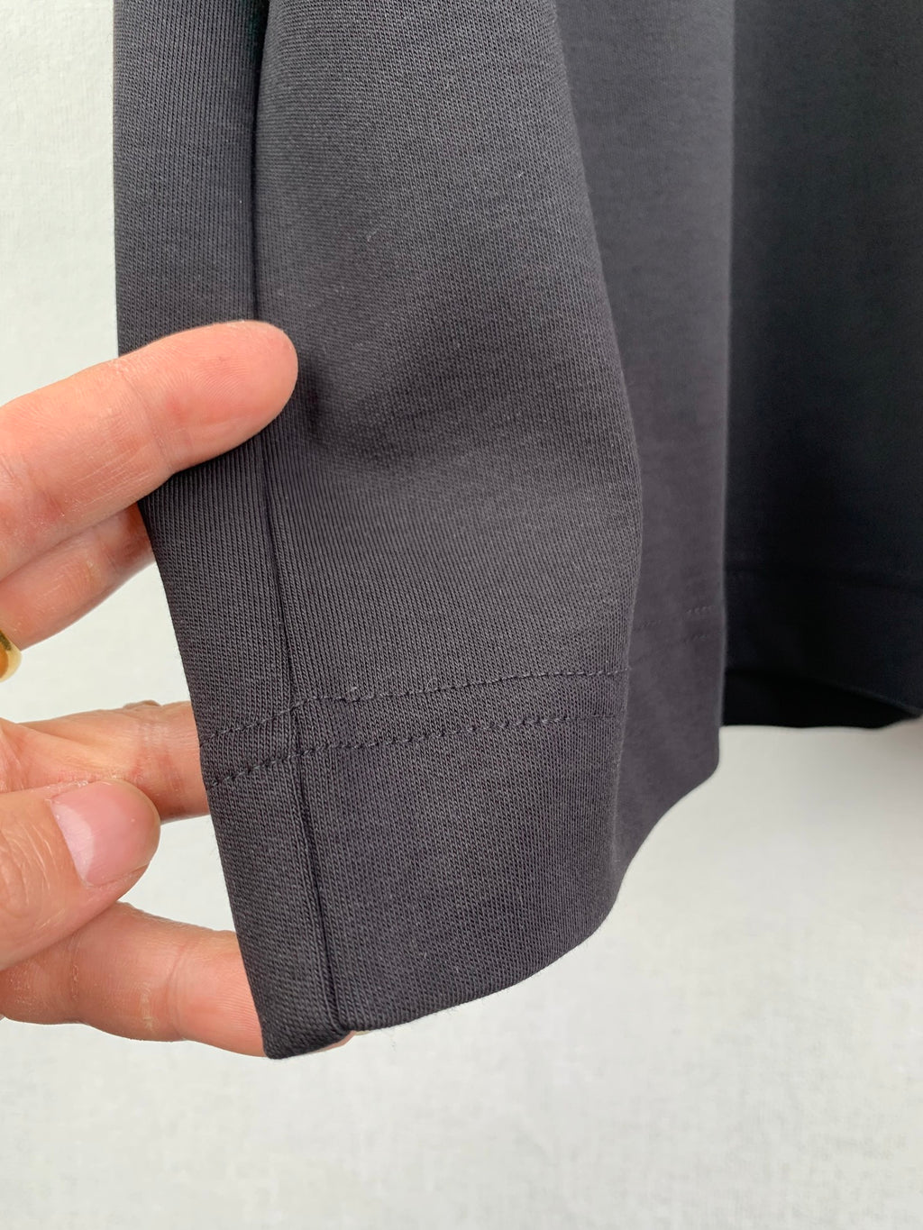 Fendi T-shirt sleeve hem with double-stitch seam detail, dark gray.