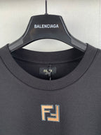 Fendi T-shirt neckline close-up with embroidered square logo at chest.