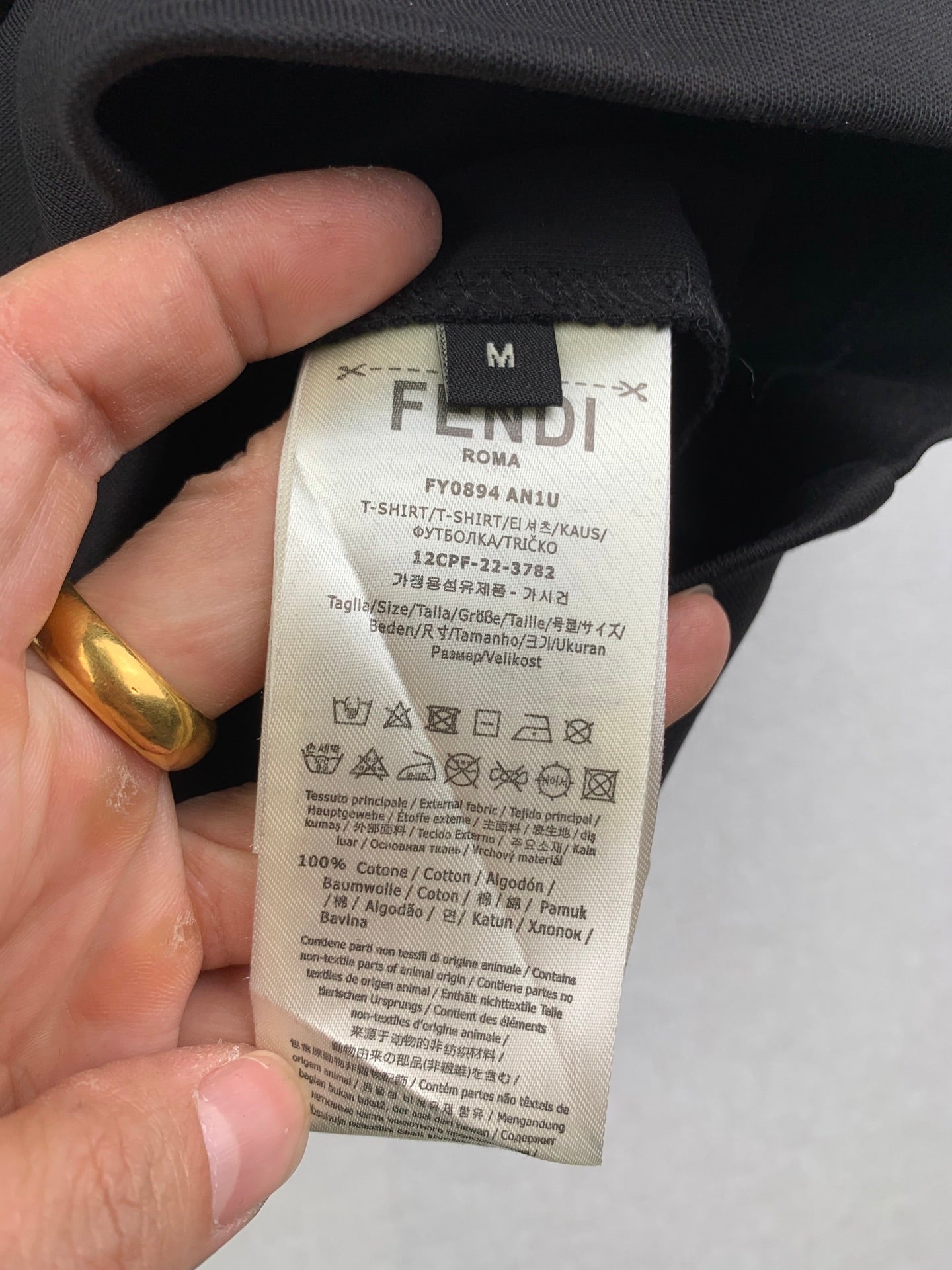 Fendi shorts care label and size tag on dark interior fabric