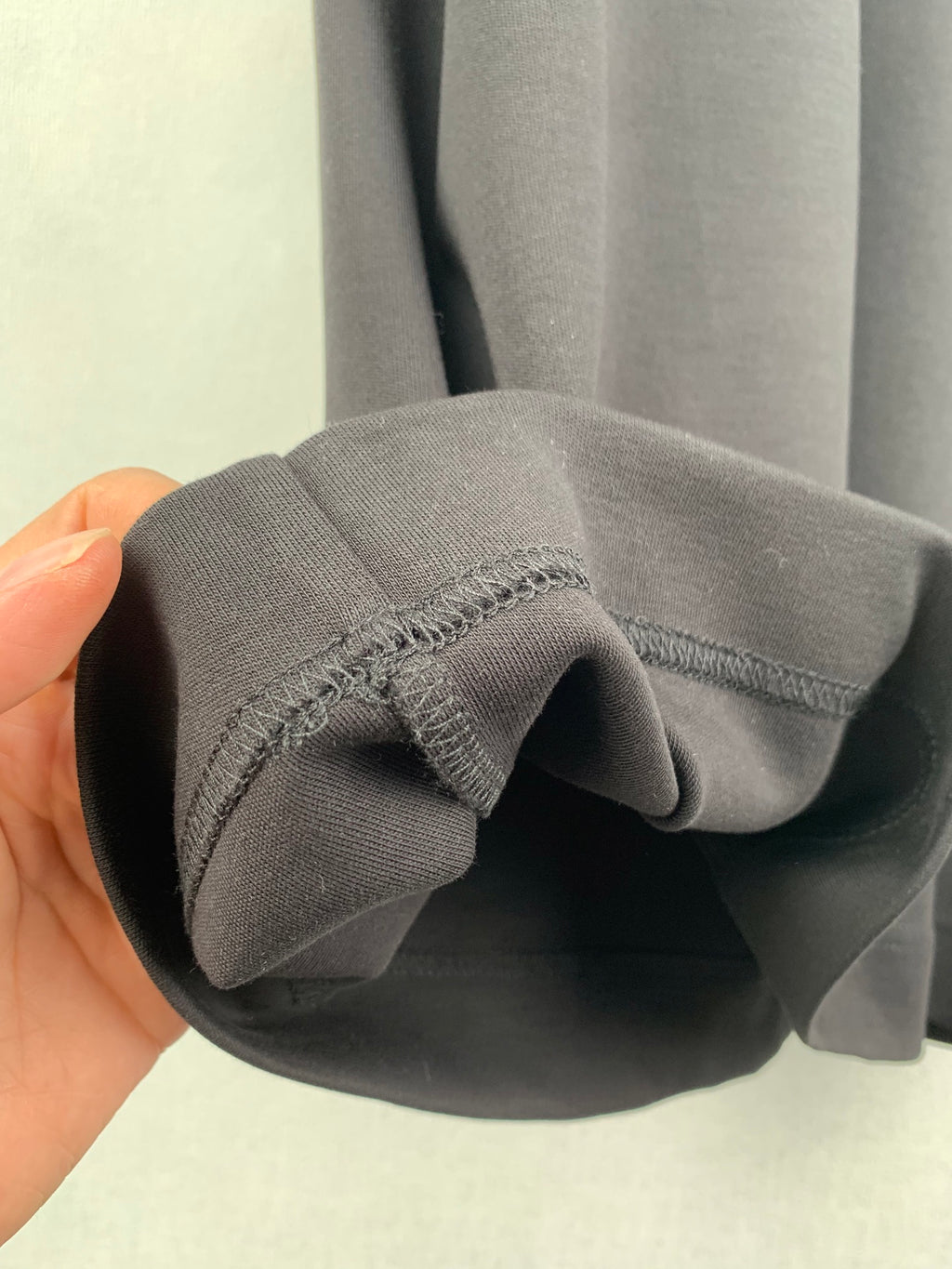 Fendi T-shirt cuff and sleeve opening edge detail in dark gray knit.