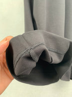 Fendi T-shirt cuff and sleeve opening edge detail in dark gray knit.