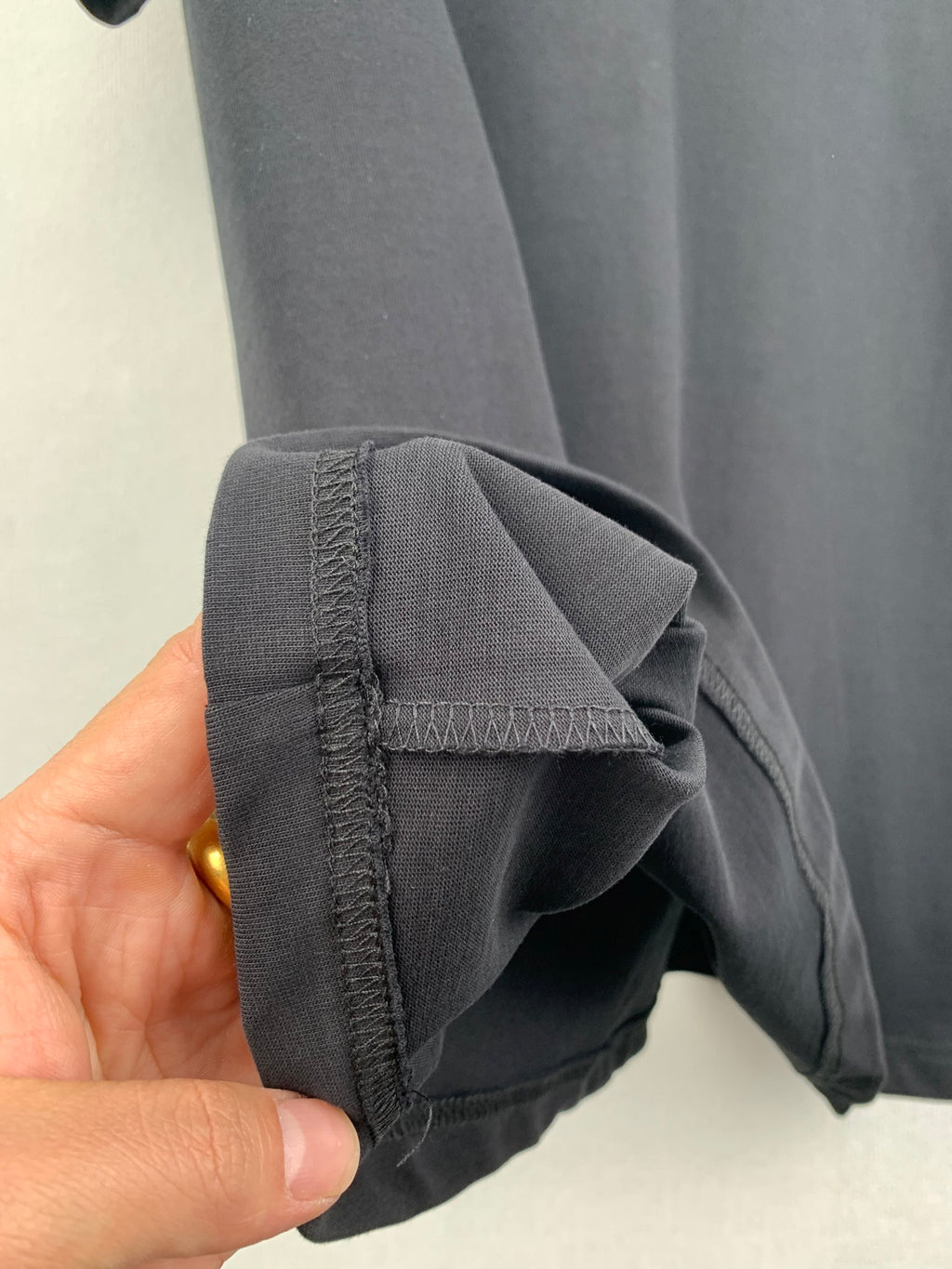 Louis Vuitton shorts hem detail, dark gray fabric with stitched edge