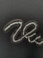 Louis Vuitton rhinestone letter detail on dark T-shirt