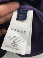 Dark purple shorts with inner care label and size tag