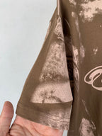 Brown T-shirt sleeve and side seam with white-toned print
