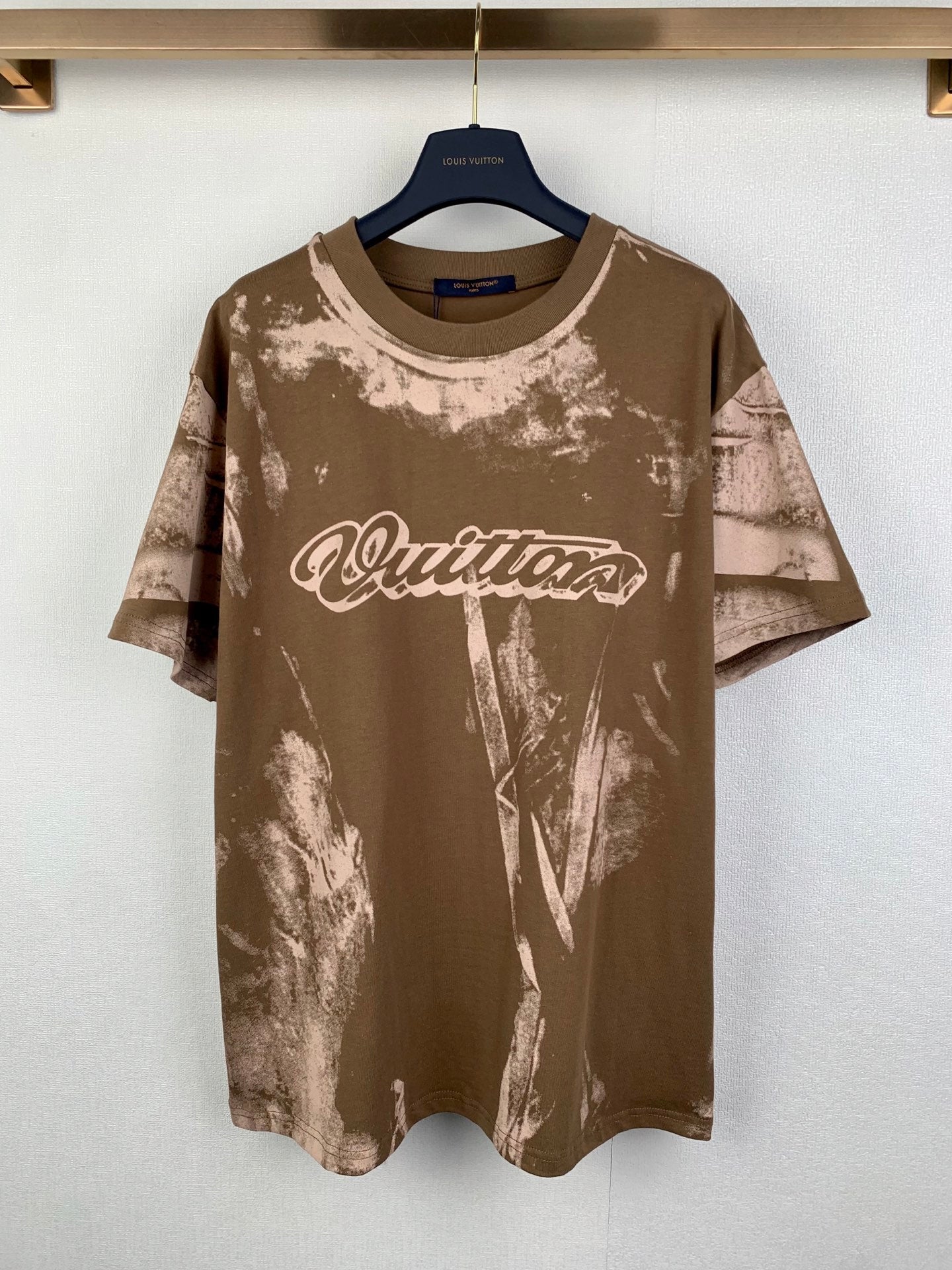 Brown short-sleeve T-shirt with white logo and allover tie-dye style print