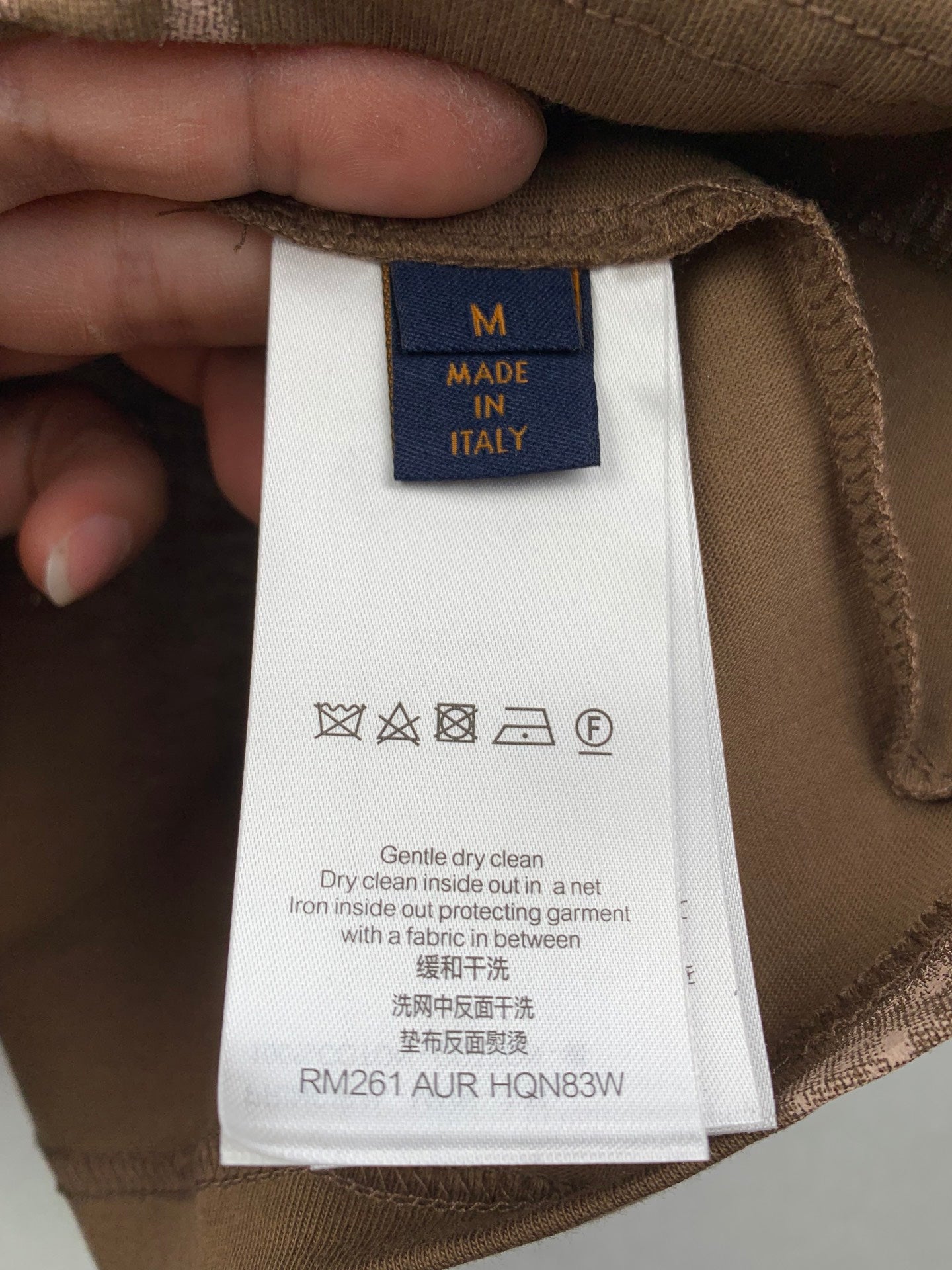 T-shirt size M care label: Made in Italy, gentle dry clean instructions