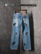 Light blue denim pants with black cross patches, back view