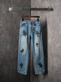 Light blue denim pants with black cross patches and straight leg