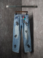 Light blue denim pants with black cross patches and straight leg