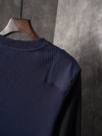 Dark ribbed knit sweater with crew neckline and shoulder seam detail