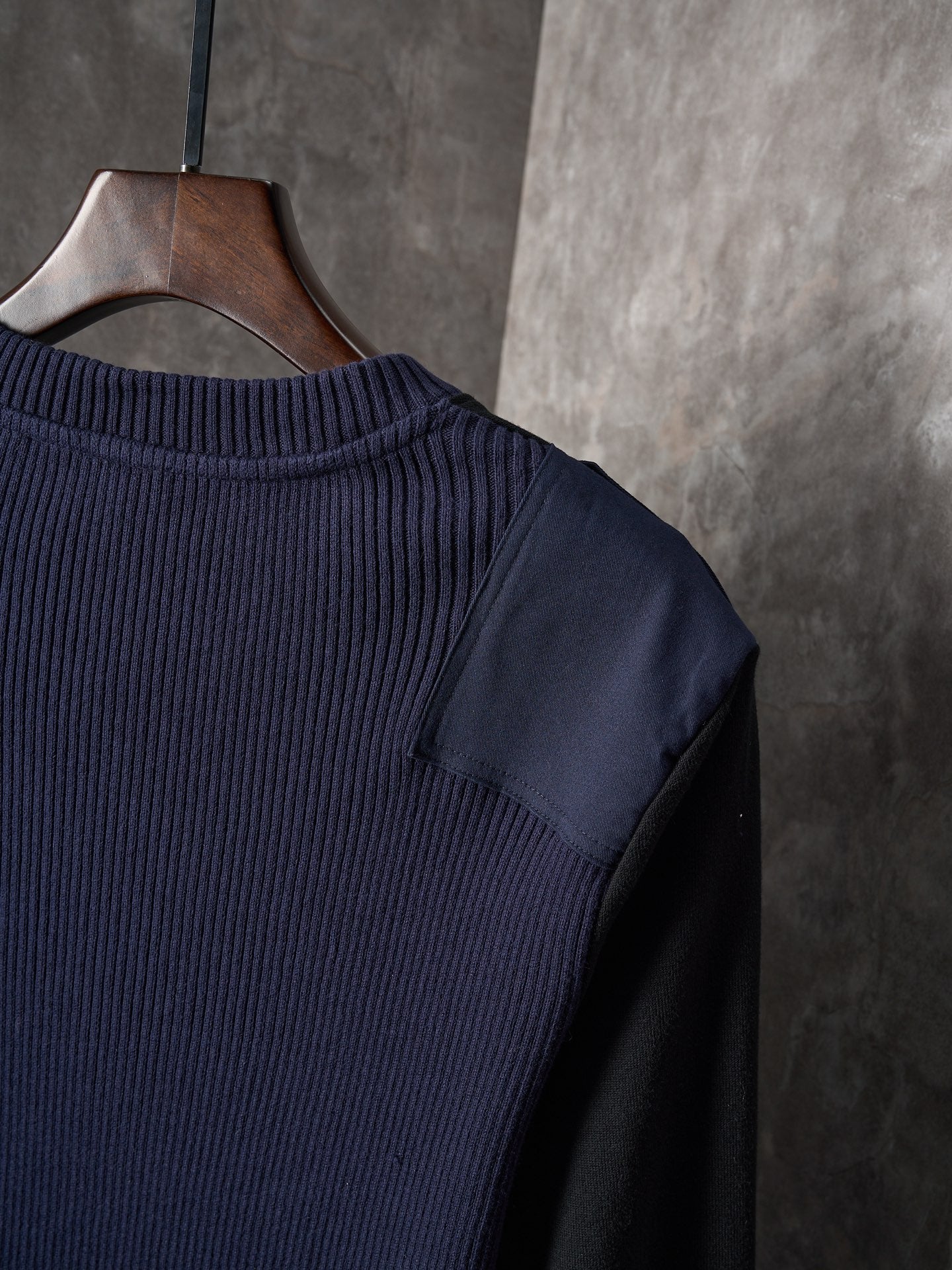 Dark ribbed knit sweater with crew neckline and shoulder seam detail
