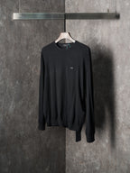 Black crewneck knit sweater with chest logo patch and long sleeves