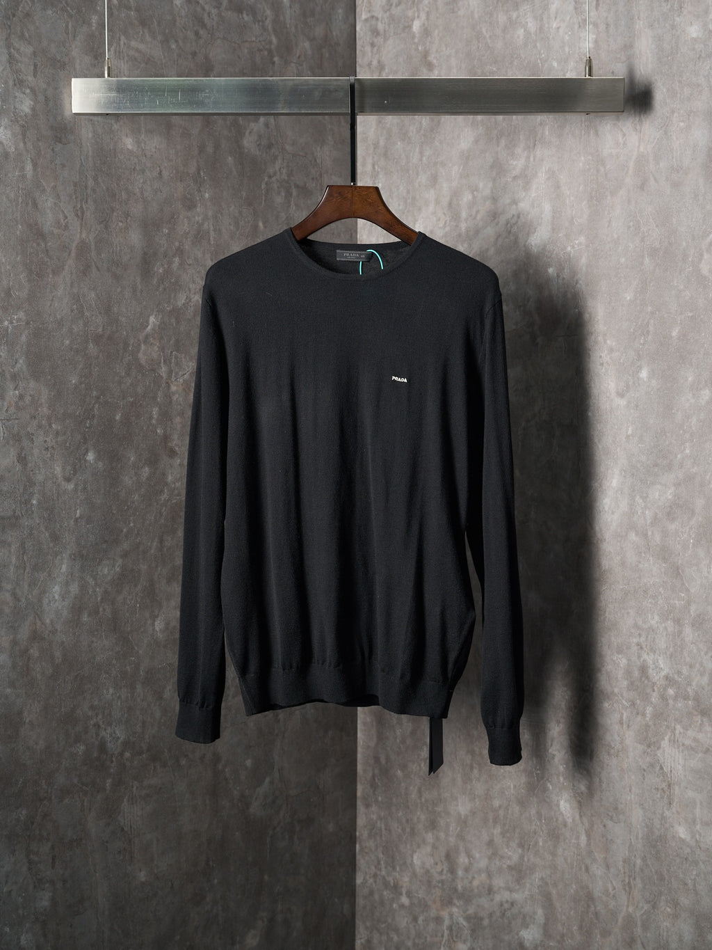Black crewneck knit sweater with small chest logo detail