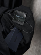 Black knit sweater with PRADA neck label and hanging price tag