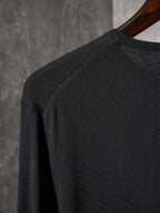 Black knit sweater shoulder and upper back with seam detail